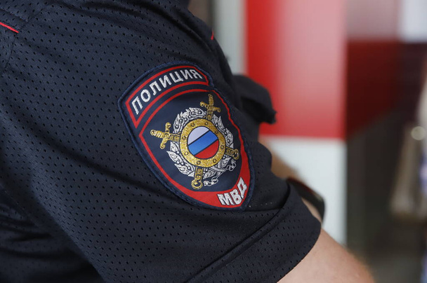 Kuvassa on osittainen kuva venäläisen poliisin univormusta, jolla on käsivarren merkki. - Valokuva, kuva