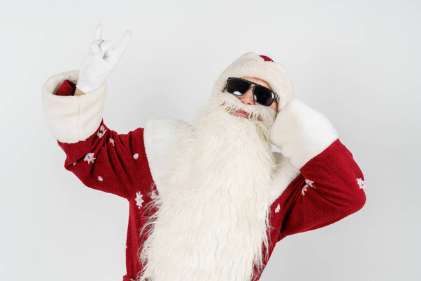 Christmas and New Years concept. Santa Claus shows a gesture by raising up two fingers. Isolated background. - Fotó, kép