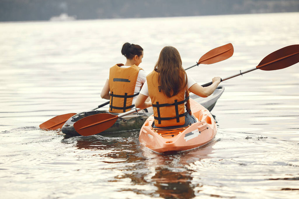 Women paddling on a lake in a kayak - Φωτογραφία, εικόνα