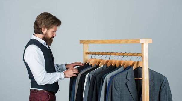 Every detail must be perfect. stylish business man at workspace. Fashion design studio. Male fashion designer. Individual measures hand of man. Man ordering business suit posing indoor - Fotoğraf, Görsel
