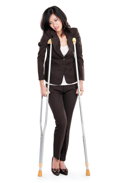 business woman with crutches - Foto, afbeelding