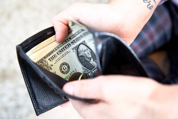 male hands holding purse with money  - Foto, Imagem