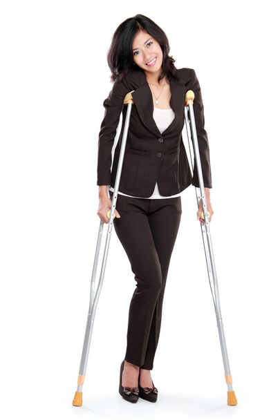 business woman with crutches - Foto, Imagen