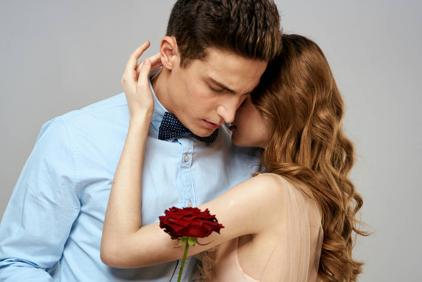 Young couple romance hug relationship dating red rose light studio background - Photo, Image