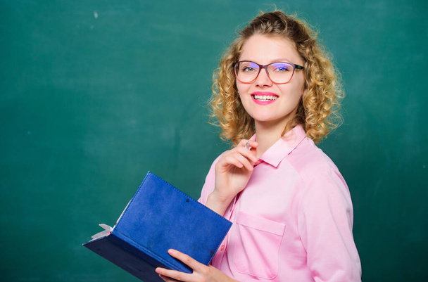 Teacher explain hard topic. Teacher best friend of learners. Pedagogue hold book and explaining information. Education concept. Woman school teacher in front of chalkboard. Passionate about knowledge - Foto, imagen