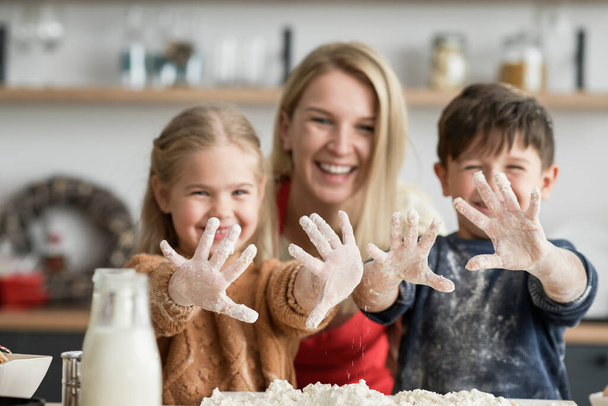 Children showing dirty hands after baking - Photo, image