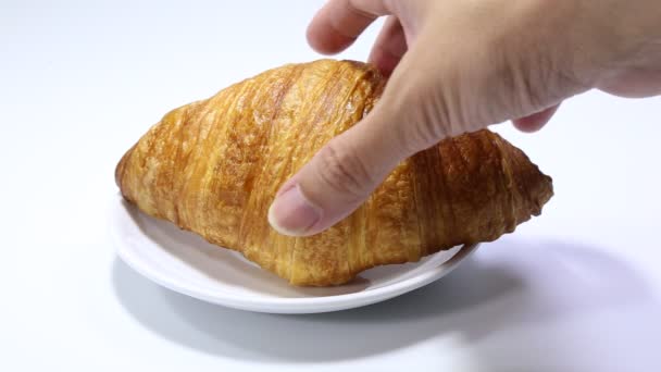 croissant leží na bílém pozadí. pečivo na izolovaném pozadí - Záběry, video