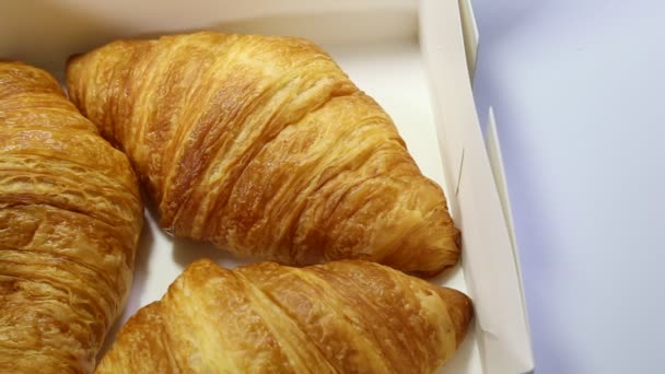 croissant ligt op een witte achtergrond. gebakken goederen op geïsoleerde achtergrond - Video