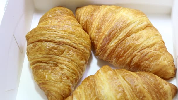 croissant si trova su uno sfondo bianco. prodotti da forno su fondo isolato - Filmati, video