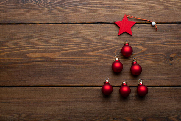 Christmas tree made of Christmas toys on a wooden background. Place for text - 写真・画像
