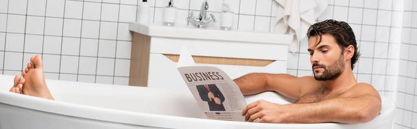 Bearded man reading business newspaper while taking bath, banner  - Photo, Image