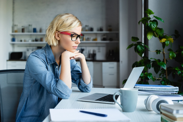 young blonde woman in eyeglasses working from home - Photo, Image