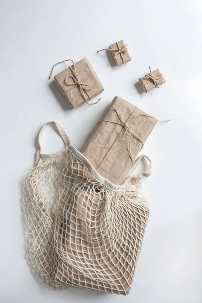 Shopping bag with gifts wrapped in kraft paper - Fotó, kép