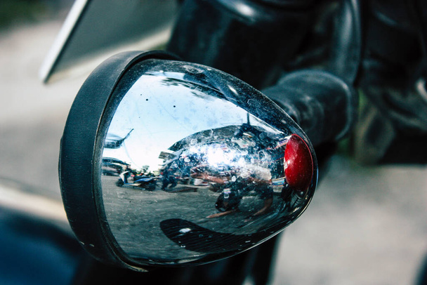 Closeup of a motorcycle rolling in the streets of the city center of the metropolitan area - Photo, Image