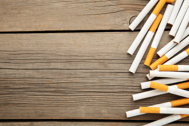 Cigarettes on a grey wooden background. Top view. - Zdjęcie, obraz