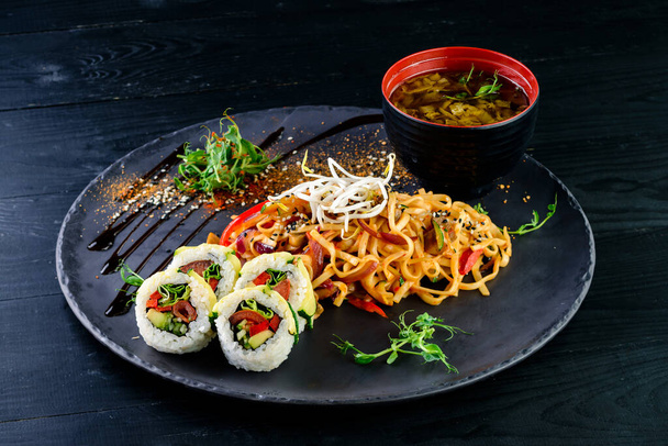 Asian food set soup, noodles and sushi rolls - Photo, Image