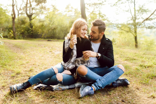 Romantic young couple in love relaxing outdoors in park - Фото, изображение