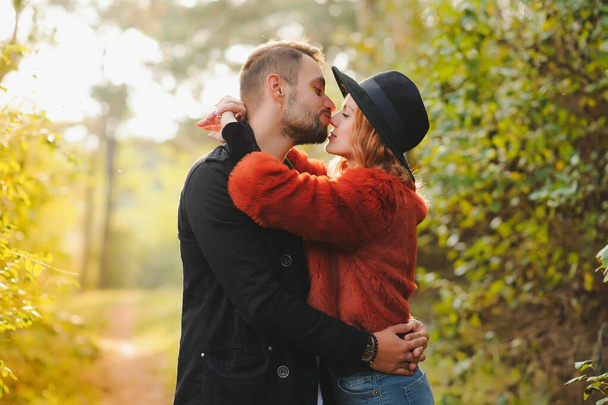 Kissing young couple in love in the autumn park - Φωτογραφία, εικόνα