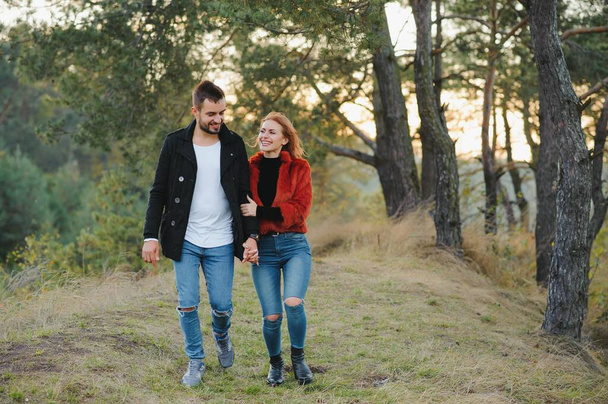 Lovers walking hand in hand in autumn park - Φωτογραφία, εικόνα
