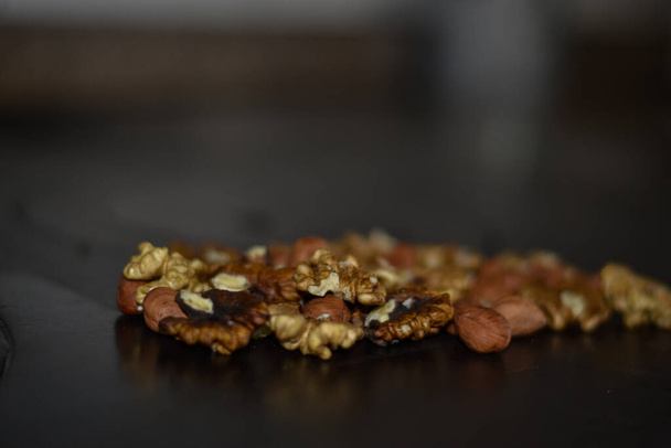 Assorted nuts on old kitchen. walnuts, hazelnuts, cashews, ... - Photo, Image