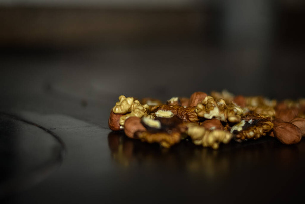 Assorted nuts on old kitchen. walnuts, hazelnuts, cashews, ... - Photo, Image