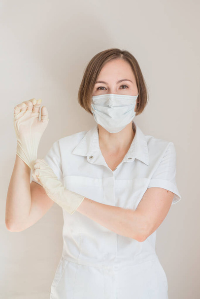 Woman doctor in gloves and medical mask  - Φωτογραφία, εικόνα