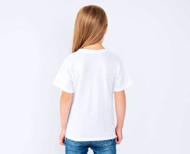 Back view of little girl in blank t-shirt - Fotó, kép