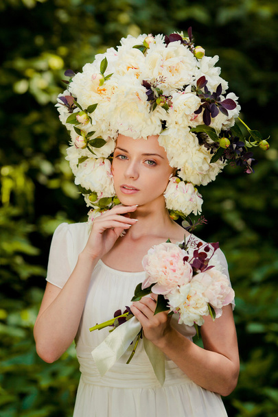 beautiful young girl with a cap of flowers on her head - Fotografie, Obrázek