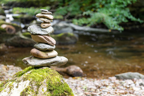 Close up of stacks of rocks on the river bank in a forest - Photo, Image