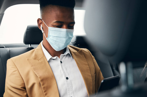 Young Businessman Wearing Mask Checking Mobile Phone In Back Of Taxi During Health Pandemic - Photo, Image