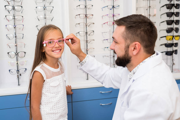 girl and doctor choose glasses - Фото, изображение