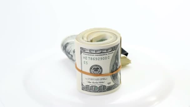 Bundle of many 100 dollar bank notes rotating on a white background - Кадри, відео
