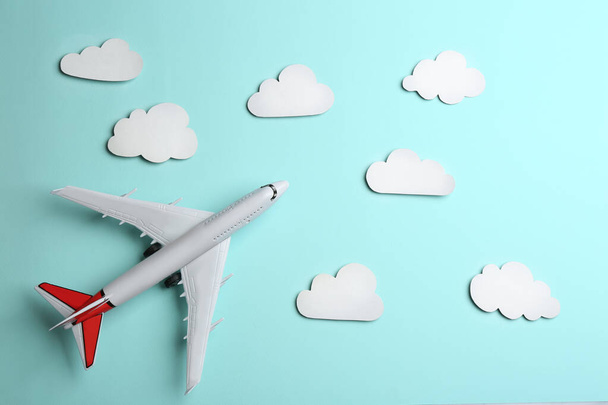Toy airplane and clouds on light blue background, flat lay - Foto, immagini