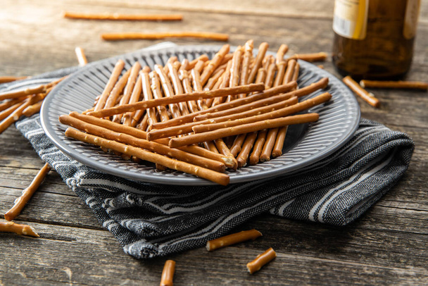 Salty sticks. Crunchy pretzels on plate. - Foto, Imagem