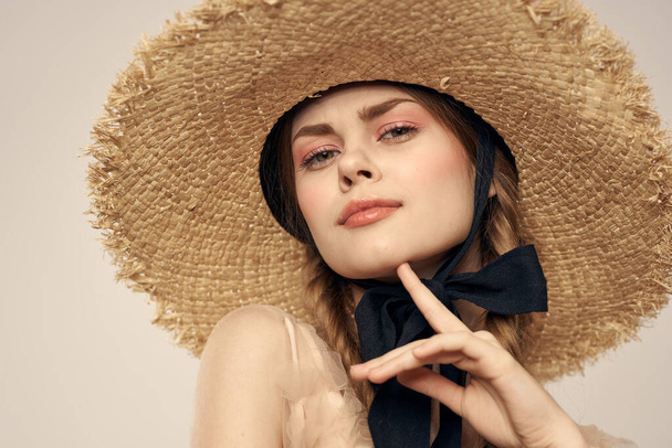 Nice girl in a straw hat with a black ribbon and in a dress on a light background romance model fun emotion - Foto, Imagem