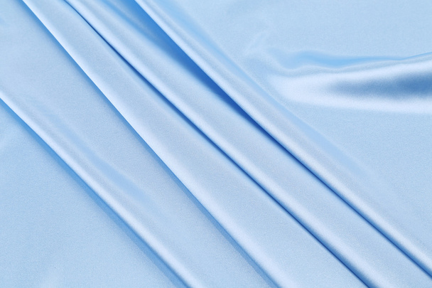 Close up of blue silk fabric background. - Фото, изображение