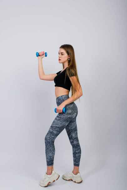 Full length portrait of smiling young fitness female in perfect shape, studio shot - Fotoğraf, Görsel