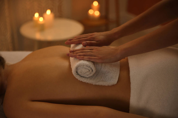 Young woman receiving hot towel massage in spa salon, closeup - Foto, Imagem