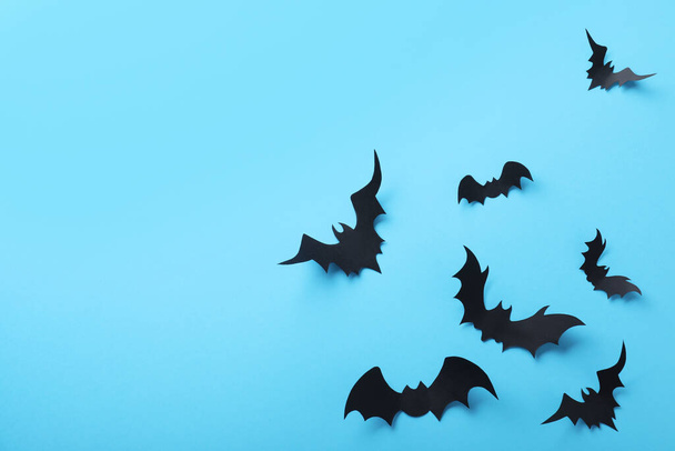 Paper bats on light blue background, flat lay with space for text. Halloween decor - Foto, Imagem