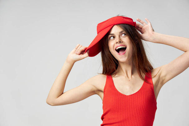 Cheerful woman look aside open mouth Red cap on head T-shirt cropped  - Photo, Image