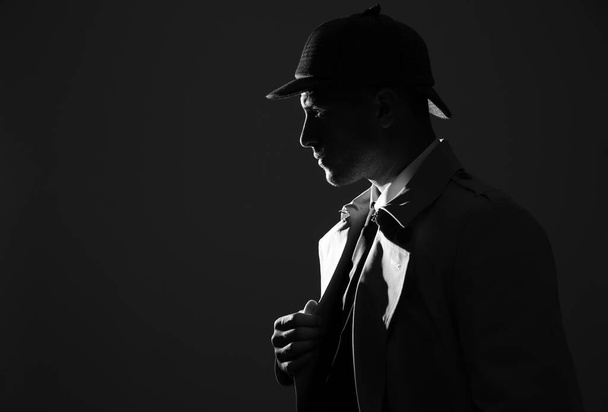 Old fashioned detective in hat on dark background, black and white effect. Space for text - Фото, зображення