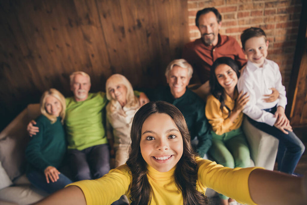 Closeup portrait photo of big full family eight people gathering cuddle embrace small girl daughter make selfie beaming smile sitting sofa generation in home evening living room indoors - Foto, imagen