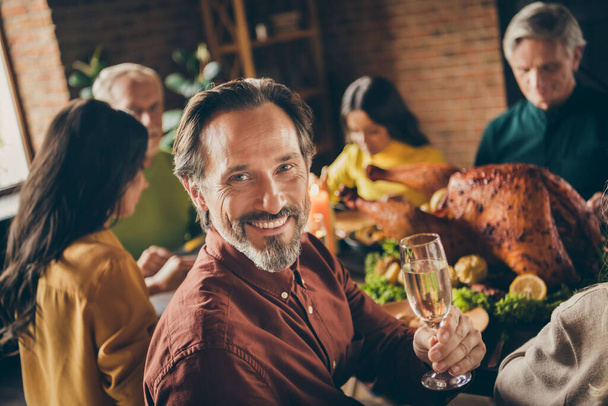 Photo of full family gathering bristled father shiny smiling hold wineglass prepare say warm words about meeting make wish served dinner big table generation home evening living room indoors - Fotó, kép