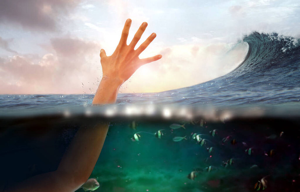 Hand of person drowning in water at sea - Photo, Image