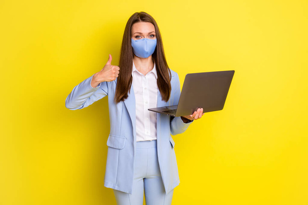 Great quarantine decision work remote concept. Agent girl marketer use laptop show thumb-up sign wear blue jacket blazer pants trousers medical mask isolated bright shine color background - Valokuva, kuva