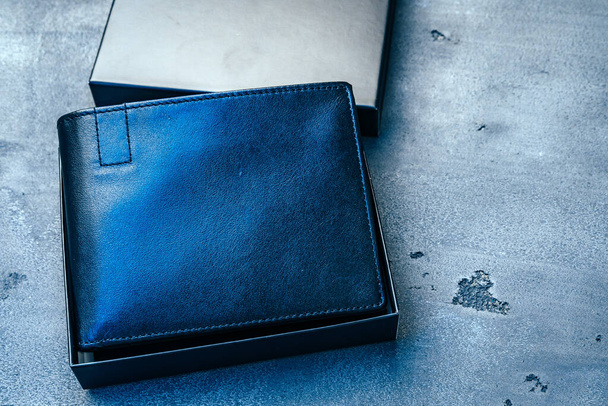 Black leather wallet on grey concrete background - Foto, Imagen