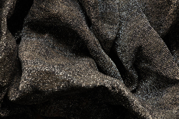 черный блестящий сверкающий шаль в качестве заднего плана крупным планом - Фото, изображение
