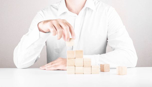 businessman climbs the career ladder. Business concept from cubes. - Fotó, kép