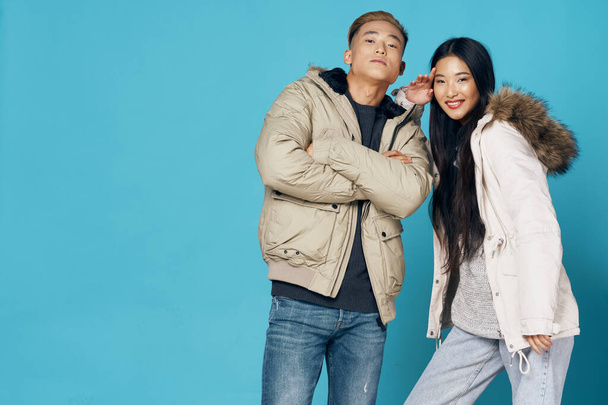 fiatalok kék háttér nő és férfi ázsiai megjelenés divatos ruhák - Fotó, kép