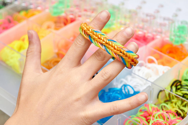 Young Woman Make Rubber Band Bracelet With A Loom Stock Photo